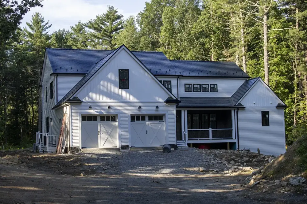 Black Interlock aluminum cedar shingle roof on a board-and-batten house in Foxborough, MA